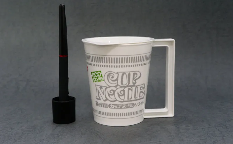 Cup Noodle mug next to a pen for scale