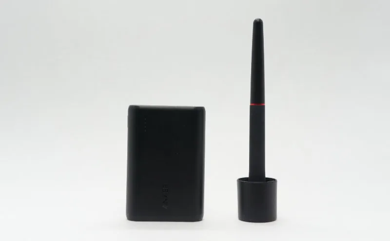 Anker PowerCore 10000 next to a smartphone for size comparison